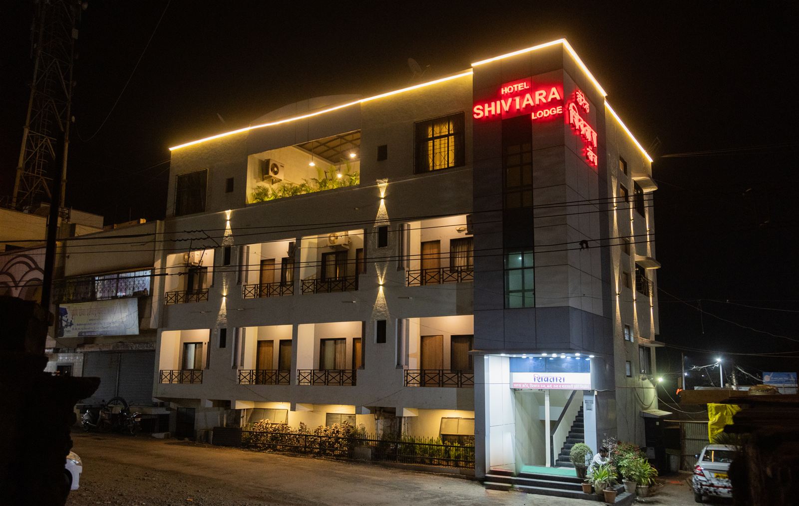 Hotel Shivtara exterior lit at night
