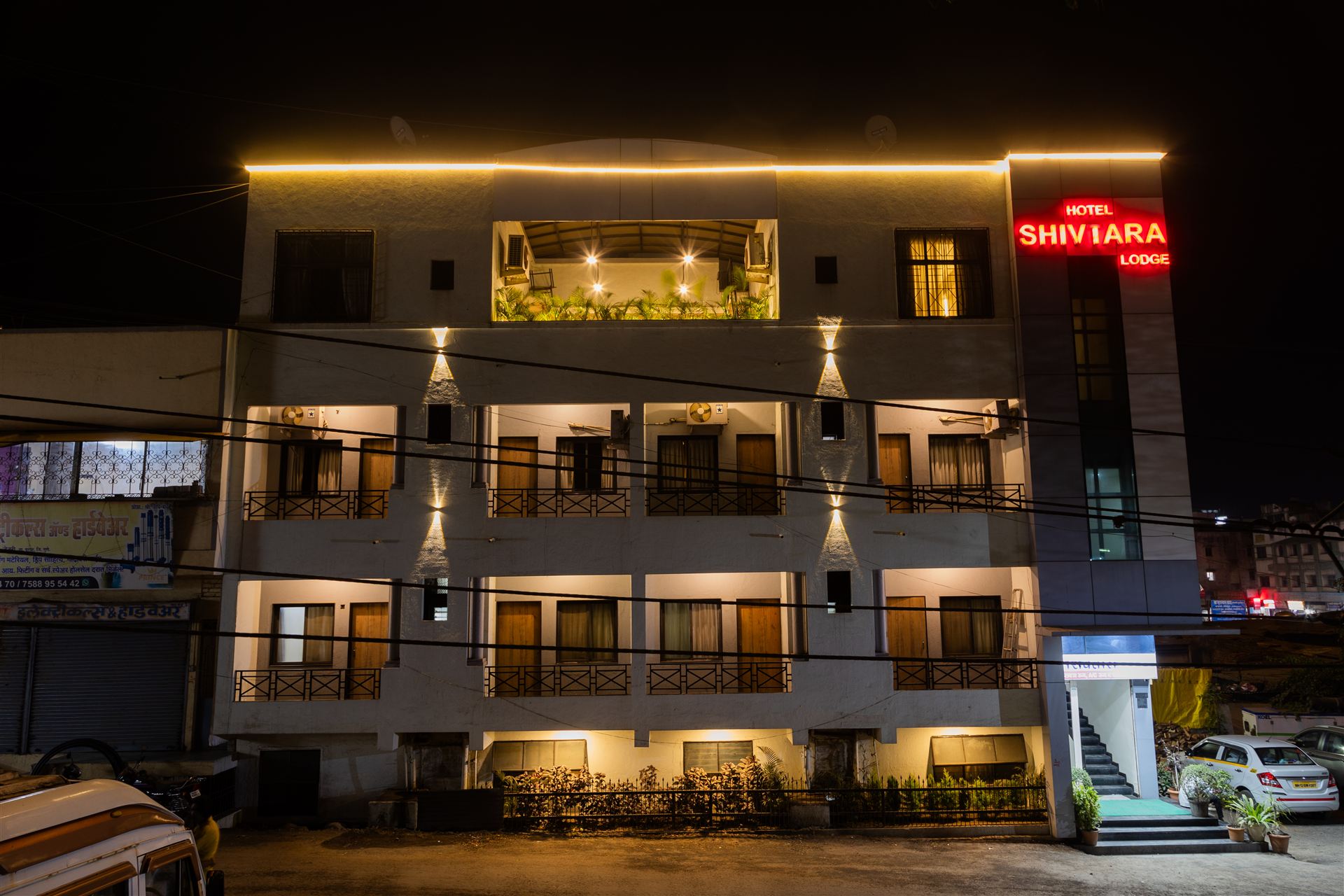 Hotel Shivtara building in Jejuri glowing with warm lights at night