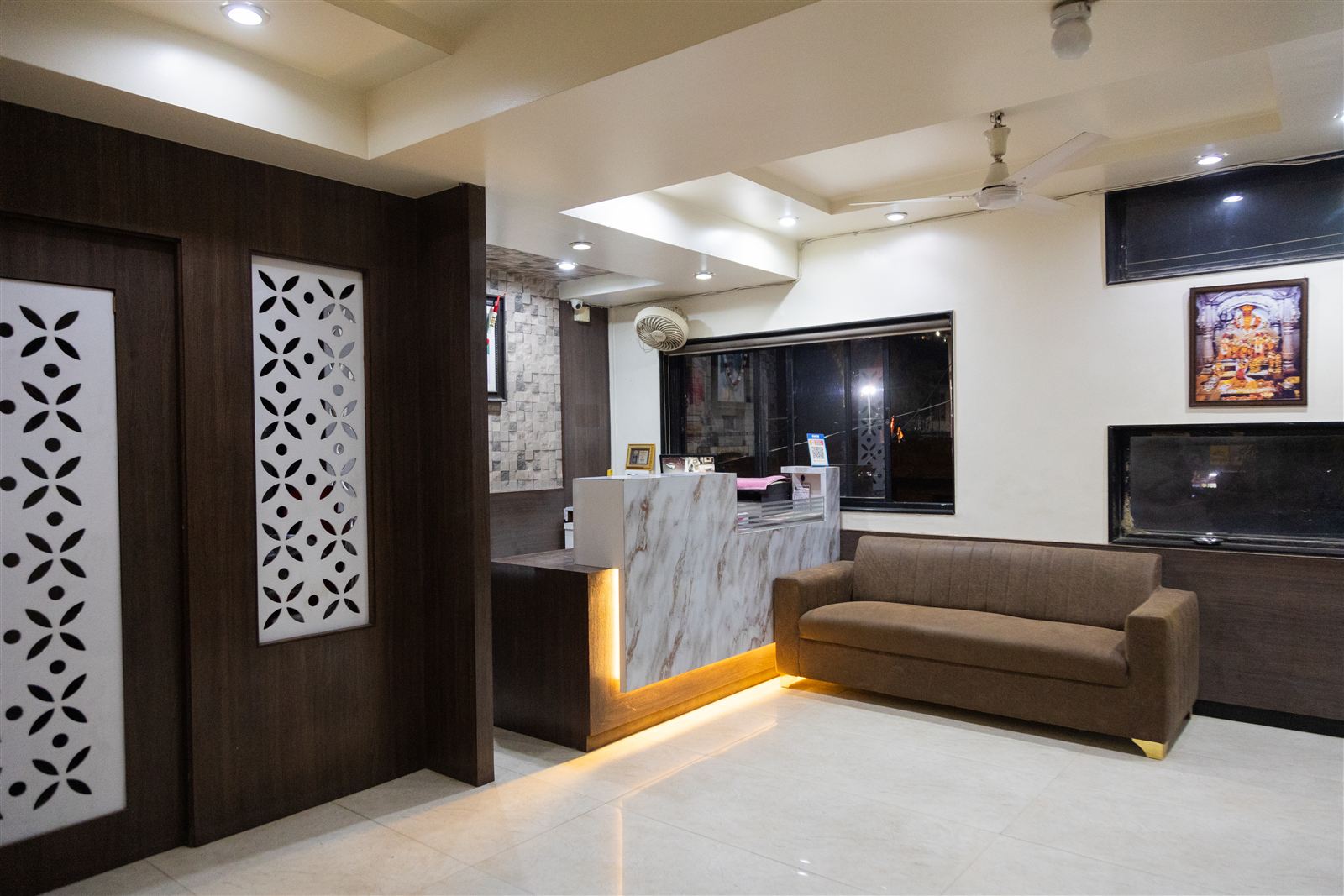 Reception desk at Hotel Shivtara with warm lighting
